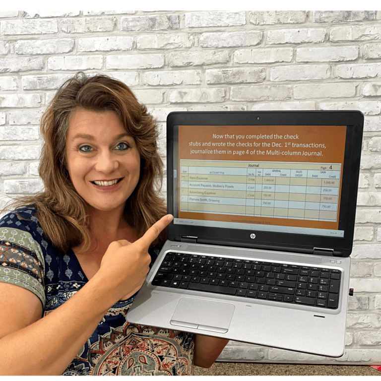 A woman pointing to the screen of her laptop.