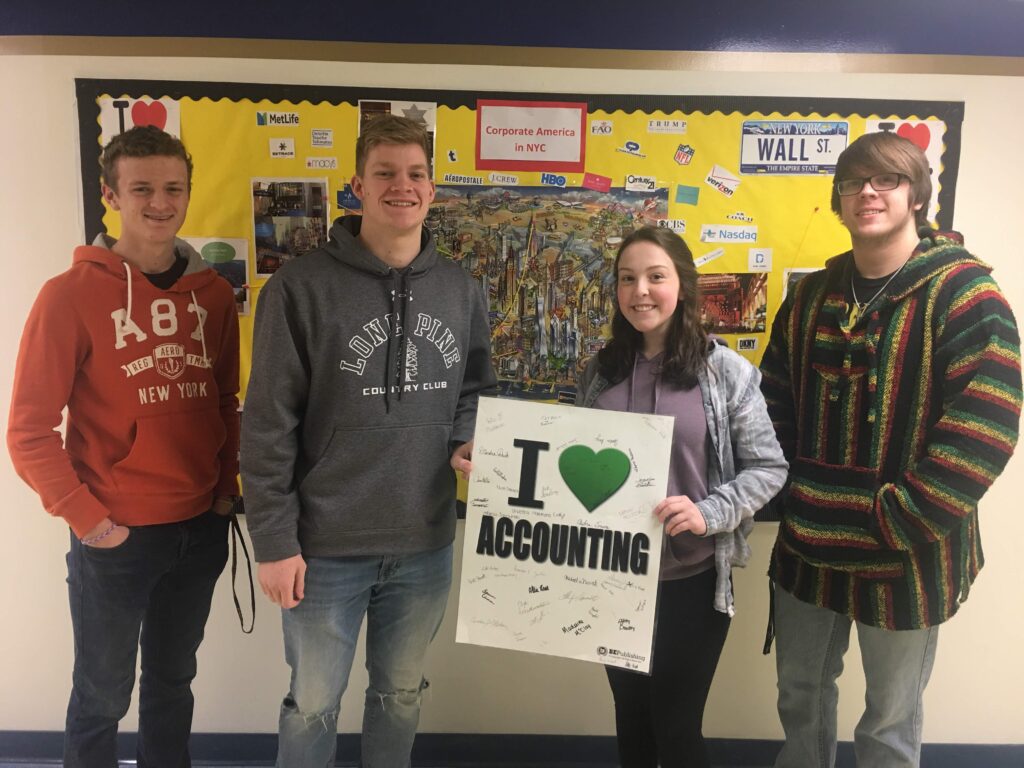 A group of people standing in front of a wall.