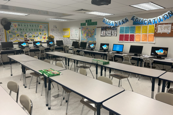 A classroom with desks and computers on it.